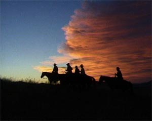 cowboys at sunset