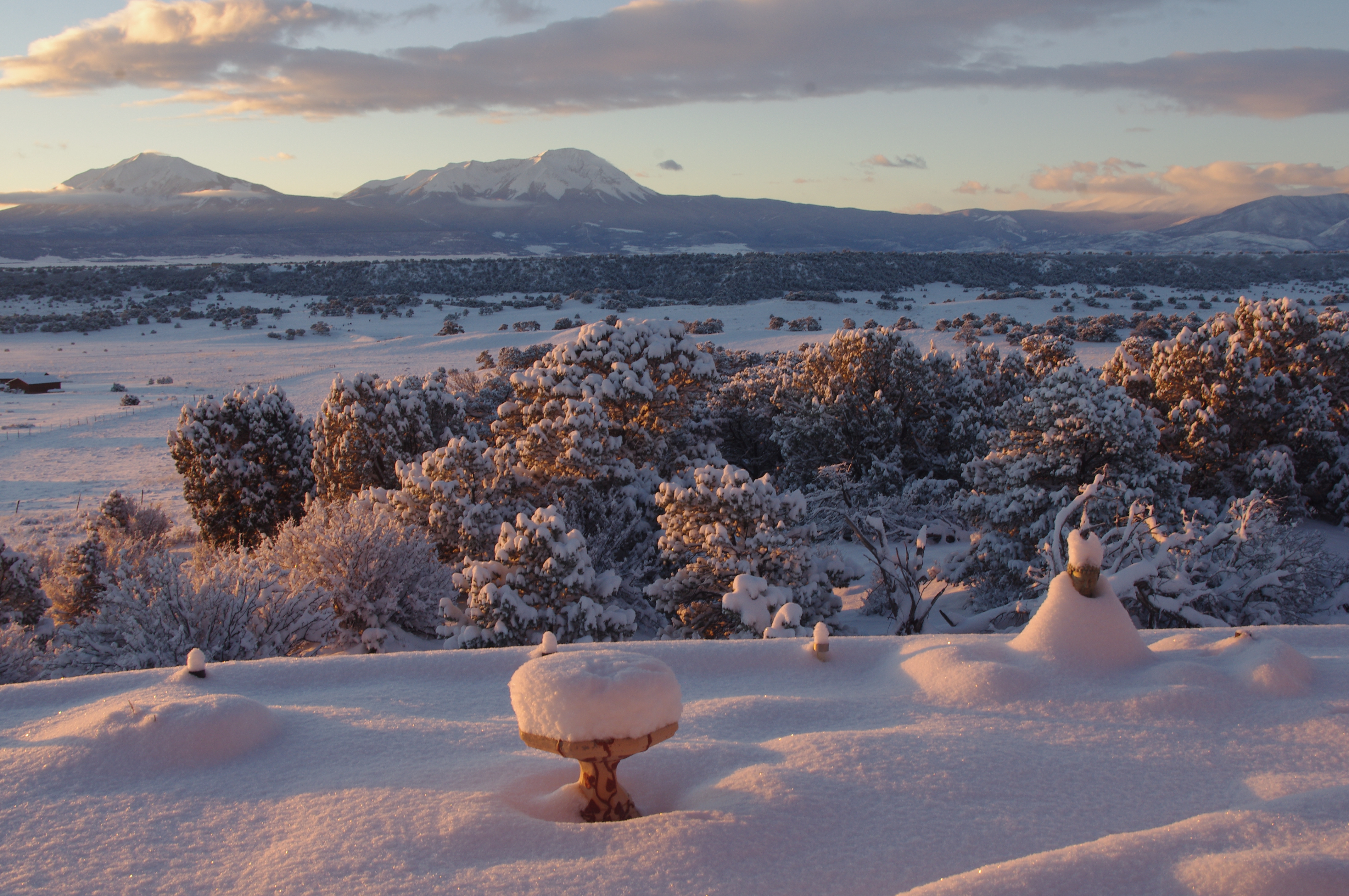 sparkling-snowy-buddha-garden-with-spanish-peaks-behind-1
